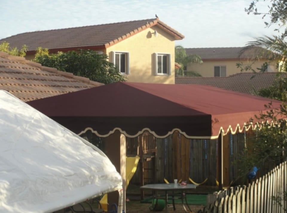 Red canvas patio awning shading a residential patio in South Florida